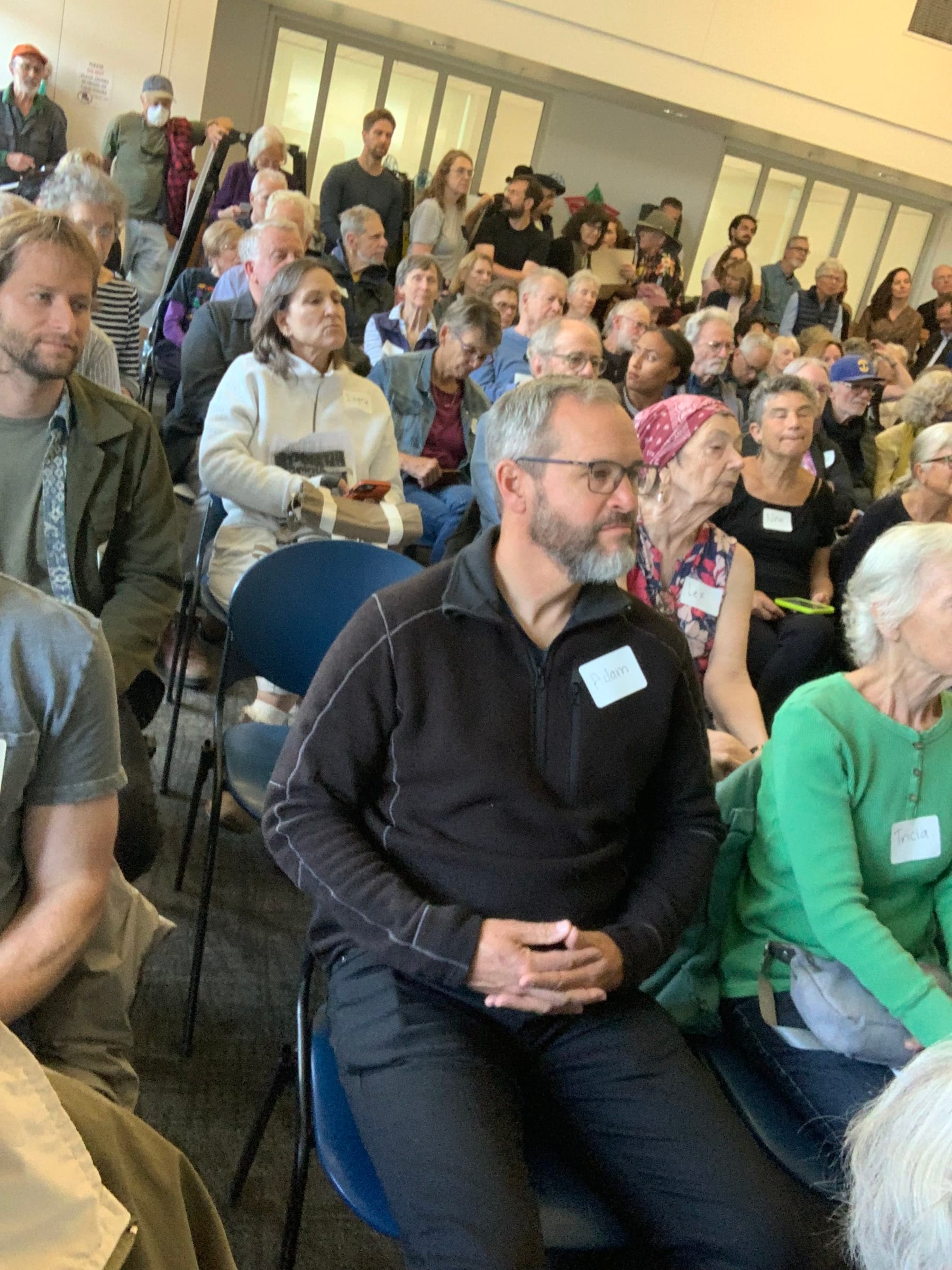 A standing-room-only crowd at the developer's 6230 Claremont Avenue senior housing presentation at the Rockridge Library.